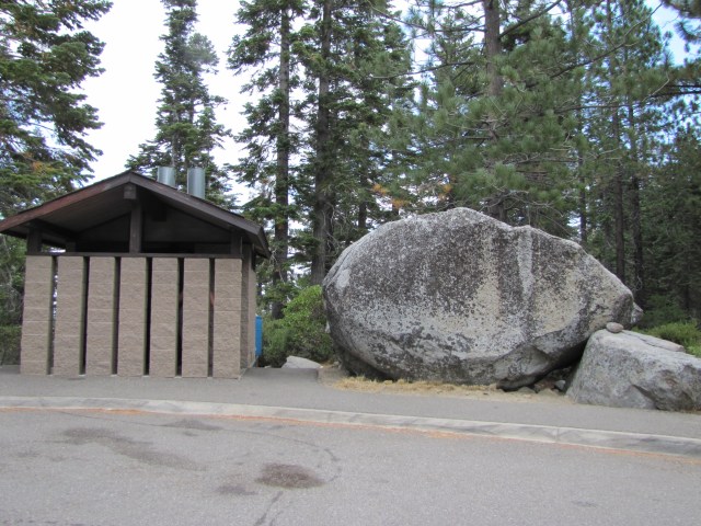 Overlook on south shore of Lake Tahoe has giant boulder next to the restrooms.